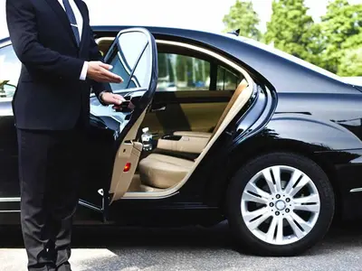 a man in a suit getting into a car at Domus Barberini in Rome