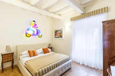 a bedroom with a bed and a wooden dresser at Al Centro Storico Roma Suite in Rome