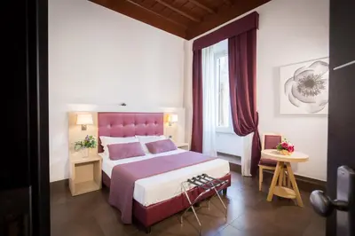a hotel room with a bed and a window at SuitInn19 in Rome