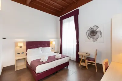 a hotel room with a bed and a window at SuitInn19 in Rome