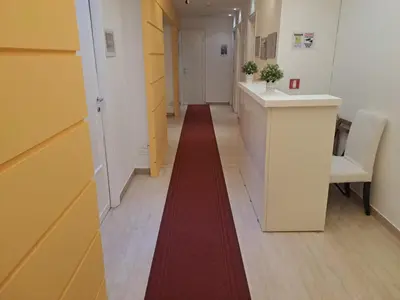 a corridor with a red carpet in a hallway at Appia Avenue 639 in Rome