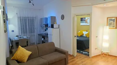 a living room with a couch and a bedroom at Appia Avenue 639 in Rome