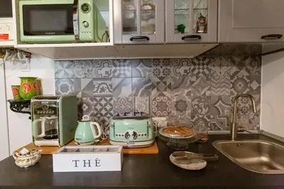 a kitchen counter with a toaster a toaster and a microwave at B&B Ventisei Scalini A Trastevere in Rome