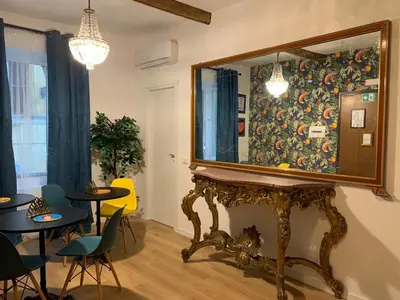 a mirror on a table in a room with chairs at B&B Ventisei Scalini A Trastevere in Rome