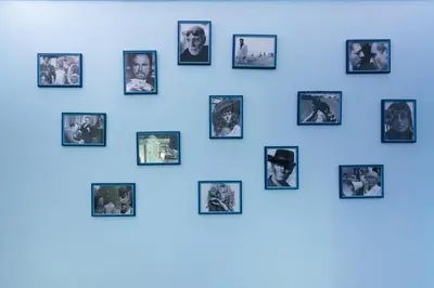 a blue wall with pictures of people at Simon Holiday House in Rome