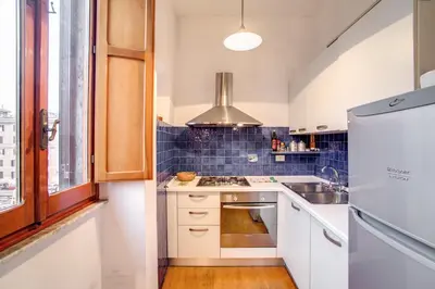 a kitchen with a sink and a refrigerator at Ponte Testaccio Loft in Rome