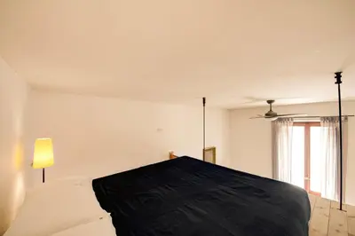 a bedroom with a bed with a black and white blanket at Ponte Testaccio Loft in Rome