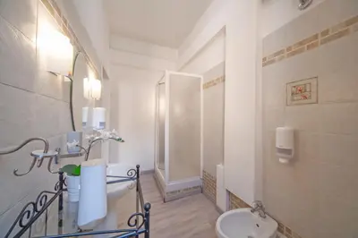 a bathroom with a toilet and a sink at San Pietro Holidays in Rome