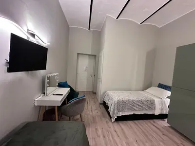 a small room with a bed and a sink at Român Holidays in Rome