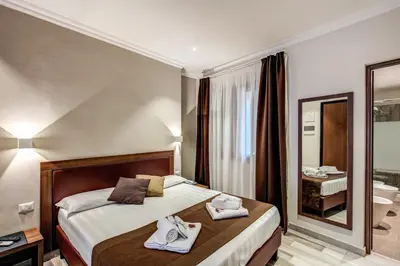 a hotel room with a bed with towels on it at House Garden in Rome