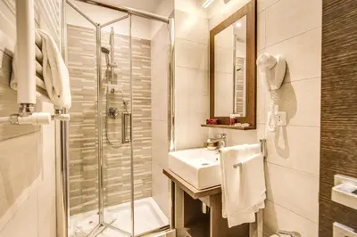 a bathroom with a sink and a shower and a toilet at House Garden in Rome