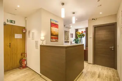 a lobby with a reception desk and a door at House Garden in Rome
