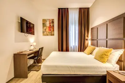 a hotel room with a bed and a desk at House Garden in Rome