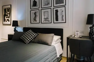 a bedroom with a bed and some pictures on the wall at The B Place Cola in Rome