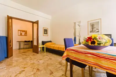 a room with a table with a bowl of flowers on it at A Casa di Pe' Casa Vacanze in Rome