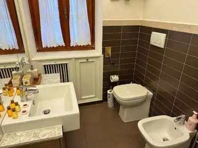 a bathroom with a white sink and a toilet at SUITE 14 - Appartamento delizioso in ROMA Centro- 200 mt da METRO B in Rome