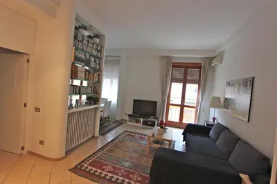 a living room with a couch and a tv at SUITE 14 - Appartamento delizioso in ROMA Centro- 200 mt da METRO B in Rome