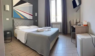 a bedroom with a bed and a table and a desk at Napoleone Suite in Rome