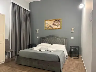 a bedroom with a bed with two towels on it at Napoleone Suite in Rome