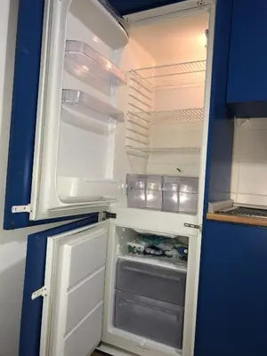an empty refrigerator with its door open in a kitchen at Le Sibille in Rome