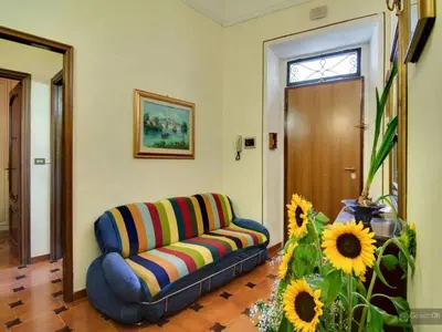 a living room with a couch and sunflowers at Oltre le Mura in Rome