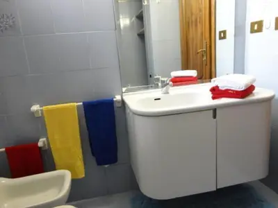 a bathroom with a sink and a toilet and towels at Oltre le Mura in Rome