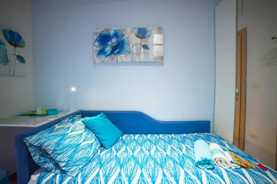 a bedroom with a blue bed with a blue comforter at Green Line in Rome