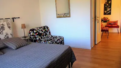 a bedroom with a bed and a chair in a room at ACasaDiEnza in Rome