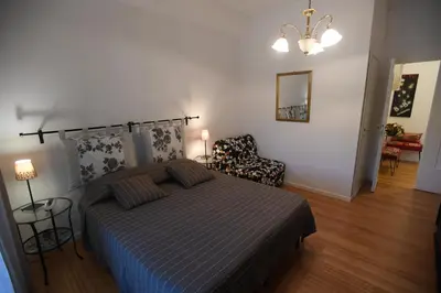 a bedroom with a bed and a chair at ACasaDiEnza in Rome