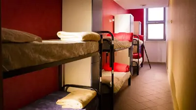 a room with three bunk beds and a window at Youth Station Hostel in Rome