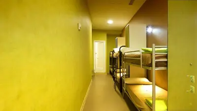 a room with several bunk beds in a yellow wall at Youth Station Hostel in Rome