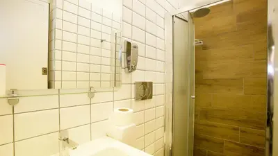 a bathroom with a sink and a shower at Youth Station Hostel in Rome