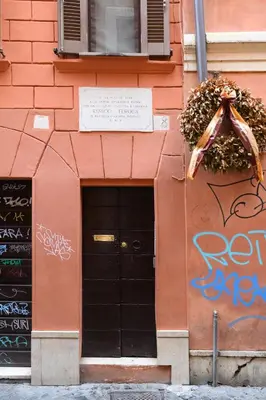 a building with graffiti on the side of it at Trust-Trastevere in Rome