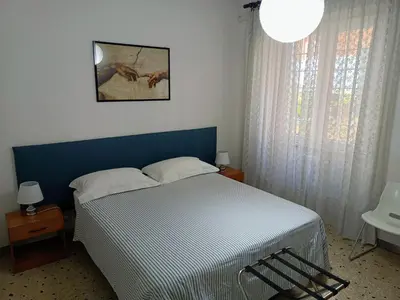 a bedroom with a bed and a picture on the wall at Trionfal Apartment in Rome
