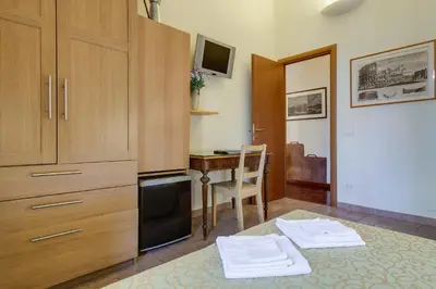 a kitchen with a desk and a table with a chair at At Rome St. Peter's in Rome