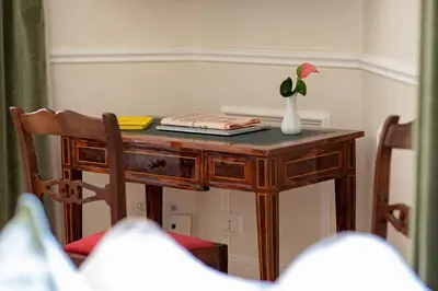 a table with a vase with a flower on it at Casa Cucu Piazza del Popolo in Rome