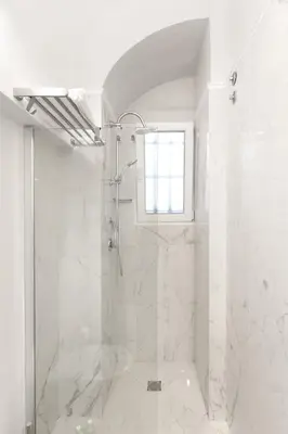 a white bathroom with a shower and a window at Casa Cucu Piazza del Popolo in Rome