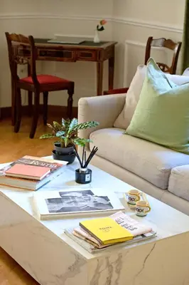 a living room with a coffee table with books at Casa Cucu Piazza del Popolo in Rome