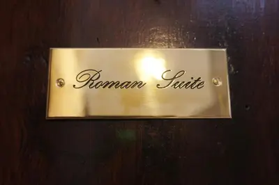 a sign on a door with the name of a room at Roman Suite in Rome