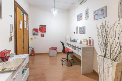 an office with a desk and a chair in a room at BB Danilo in Rome