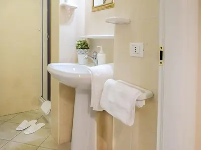 a bathroom with a white sink and a shower at Re Monti in Rome
