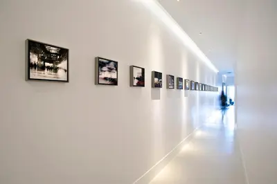 a hallway with a row of pictures on a wall at Piazza di Spagna 9 in Rome