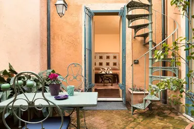 an open door to a patio with a table and chairs at Buonanotte Garibaldi in Rome