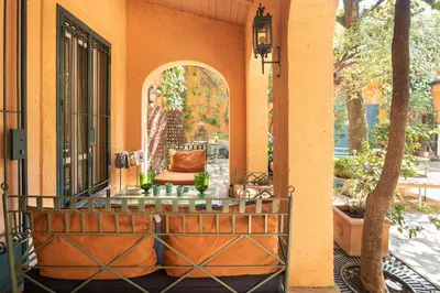 a porch with a chair and an open door at Buonanotte Garibaldi in Rome