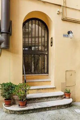 an entrance to a building with a gate and some plants at All'Ombra Del Cupolone Guest House in Rome