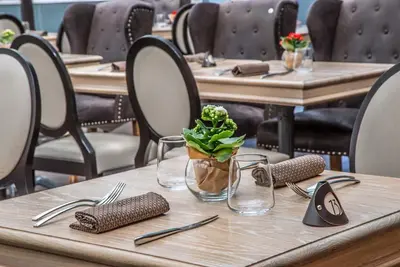 a table with a vase with a plant on it at Hotel Caravel in Rome