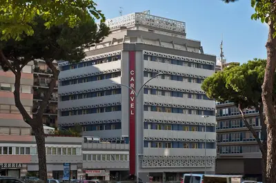 a tall building with a sign on the side of it at Hotel Caravel in Rome