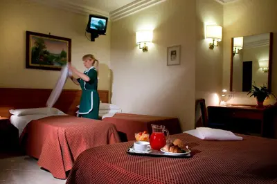 a woman is in a hotel room with two beds at Hotel Delle Muse in Rome