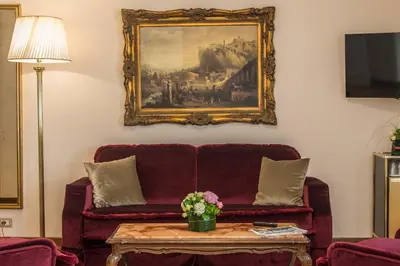 a bedroom with a bed and a dining room at Hotel Forum in Rome