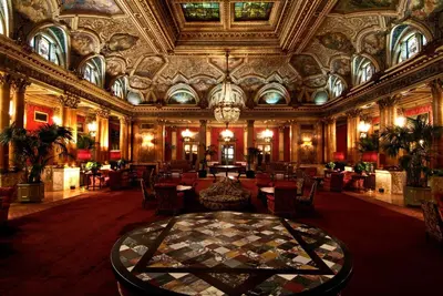 a large room with a table and chairs in a building at Grand Hotel Plaza in Rome